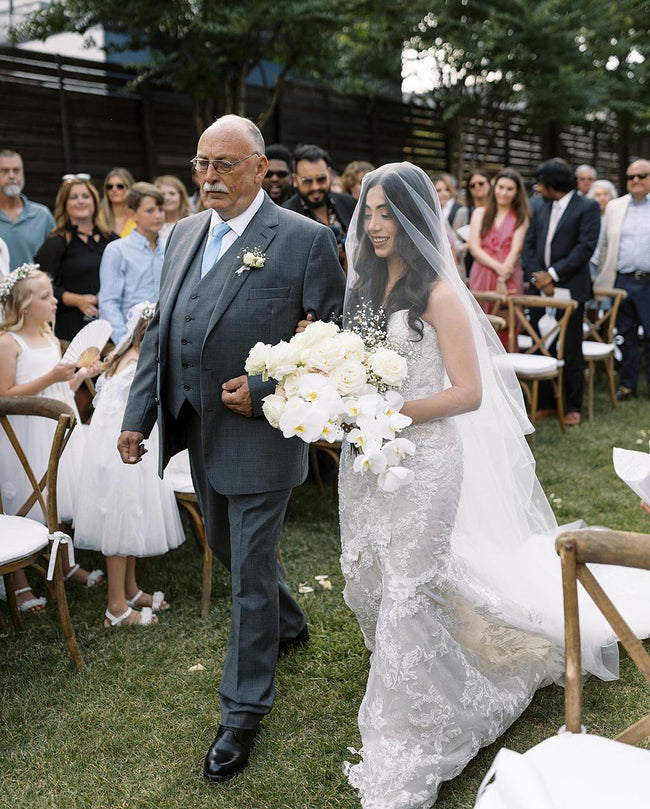 Wedding veil with hair down. Bride walking down the aisle with veil over face.