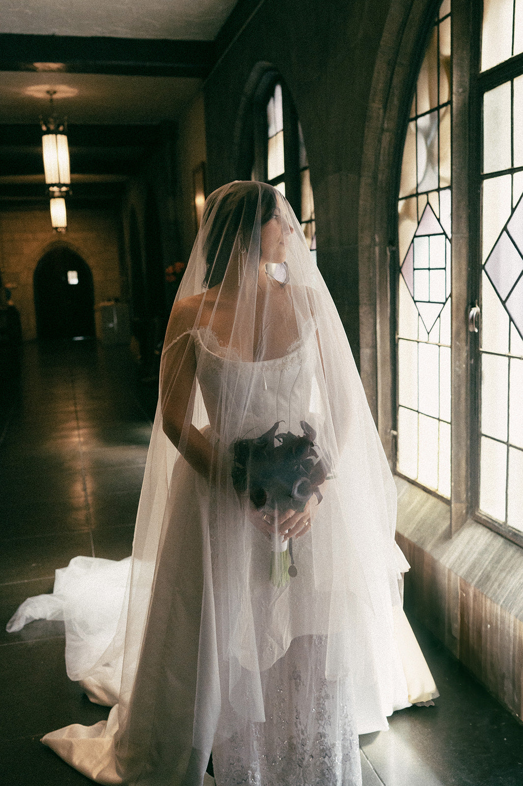 Bride wearing a sheer drop veil with corset wedding dress.