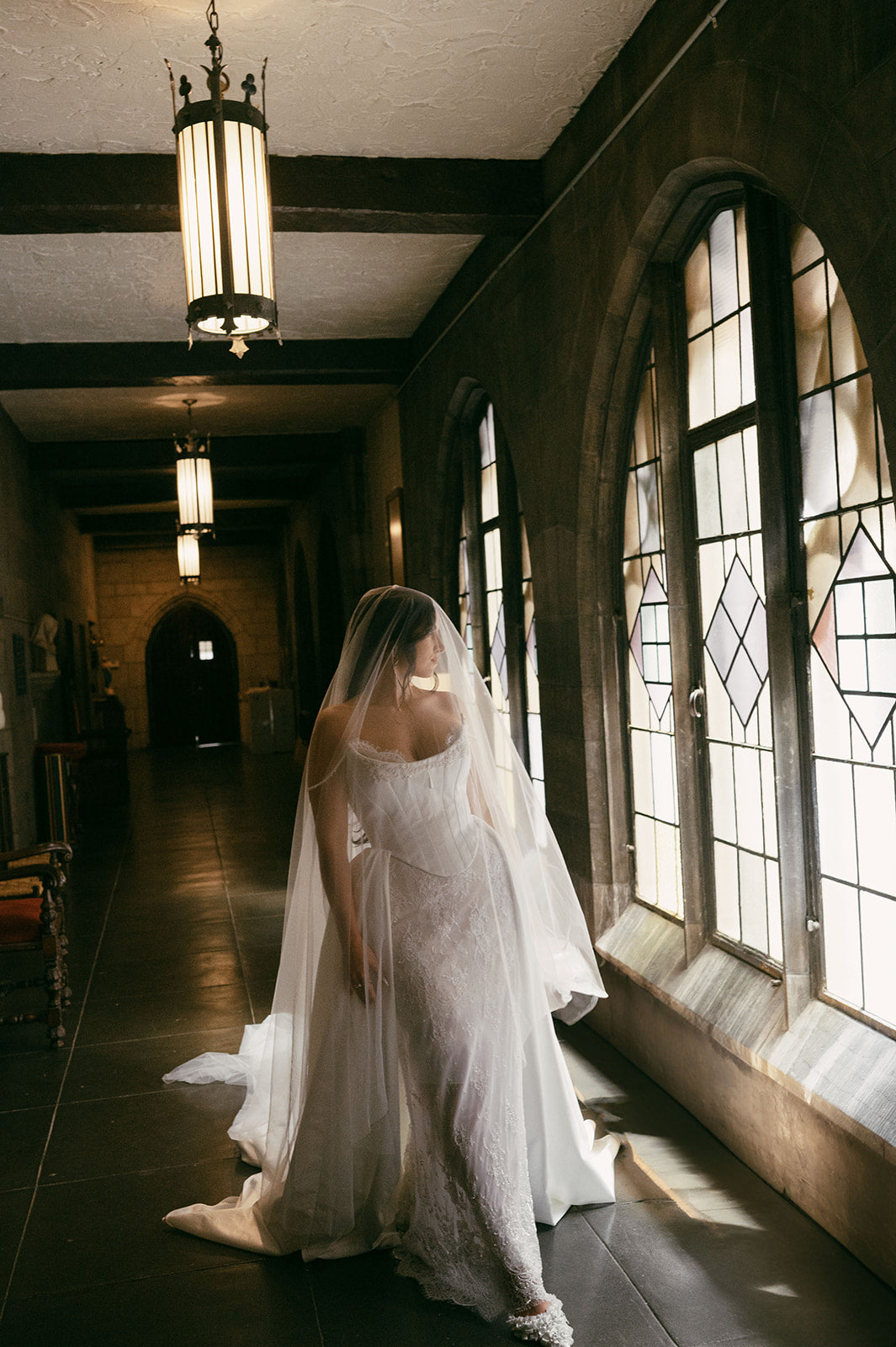 Bride wearing a sheer drop veil with corset wedding dress.